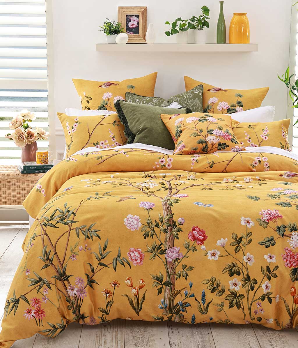 Opulent and artistic, M.M Linen Yuki design of charming blossoms and fauna on a sunny and soft, golden background