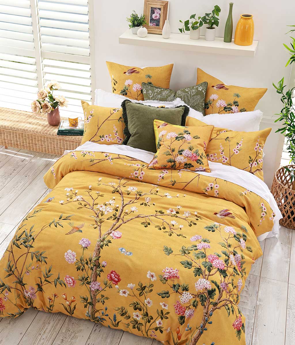 Opulent and artistic, M.M Linen Yuki design of charming blossoms and fauna on a sunny and soft, golden background